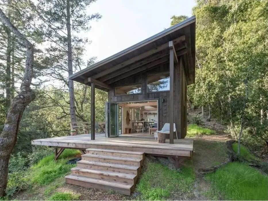 Detached building design shared by PINEFORGE, with a deck and a sloping roof
